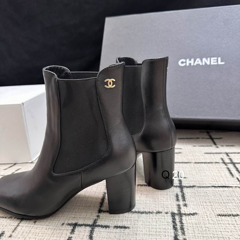 Chanel black leather Chelsea ankle boots with gold CC logo hardware and block heel, shown with original Chanel box