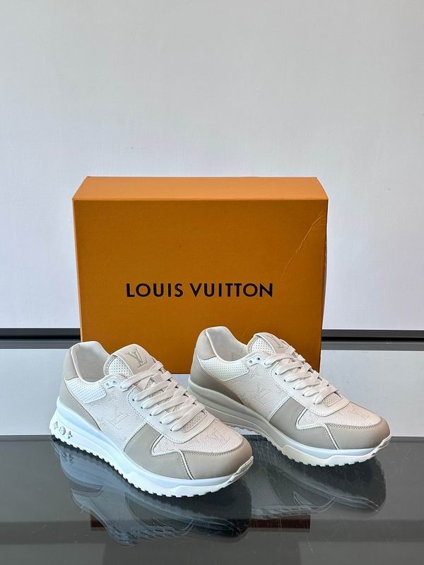 Premium monogram low-top sneakers in cream and off-white with grey suede accents, displayed with orange luxury box
